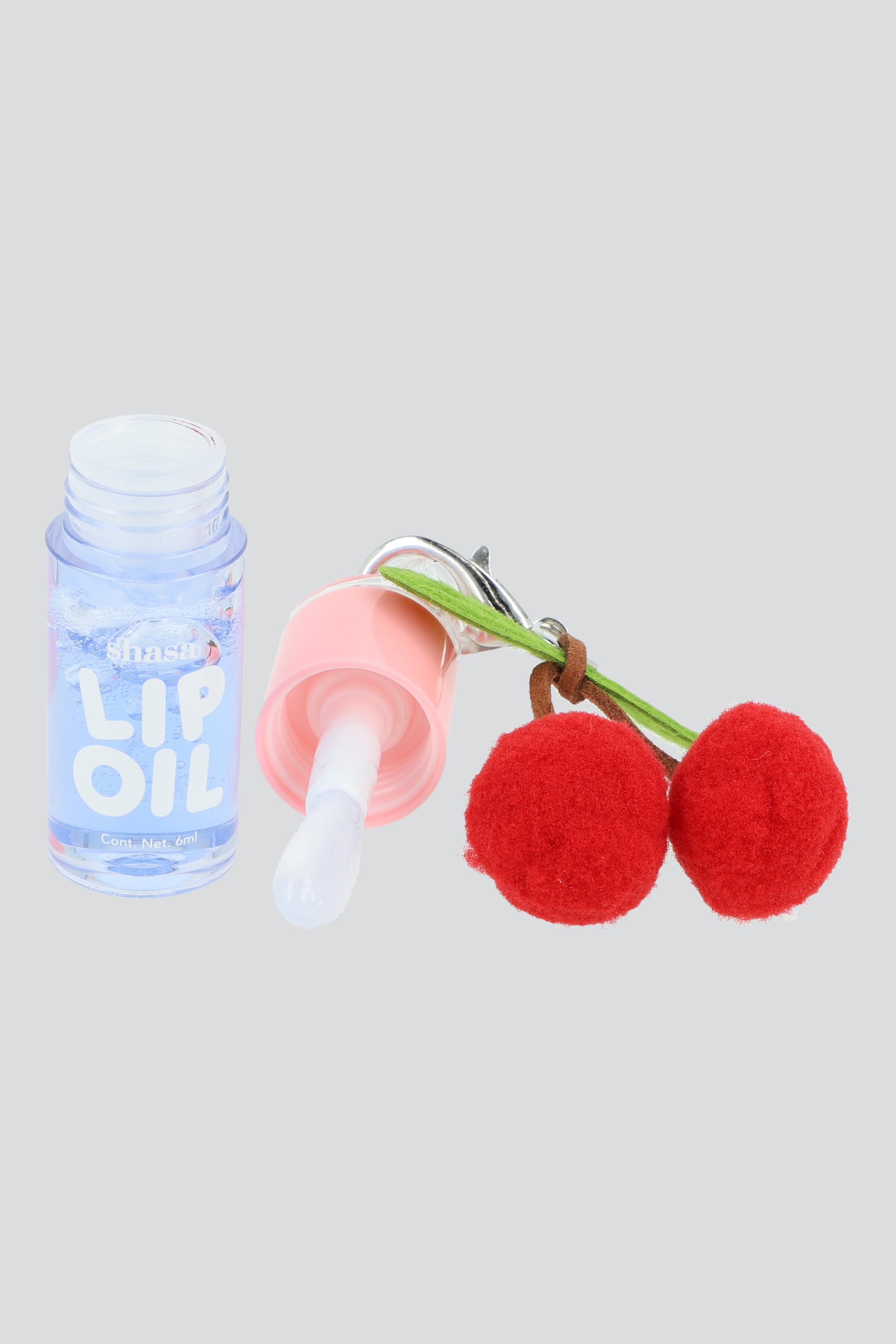 Lip oil charm cerezas pompon AZUL PASTEL
