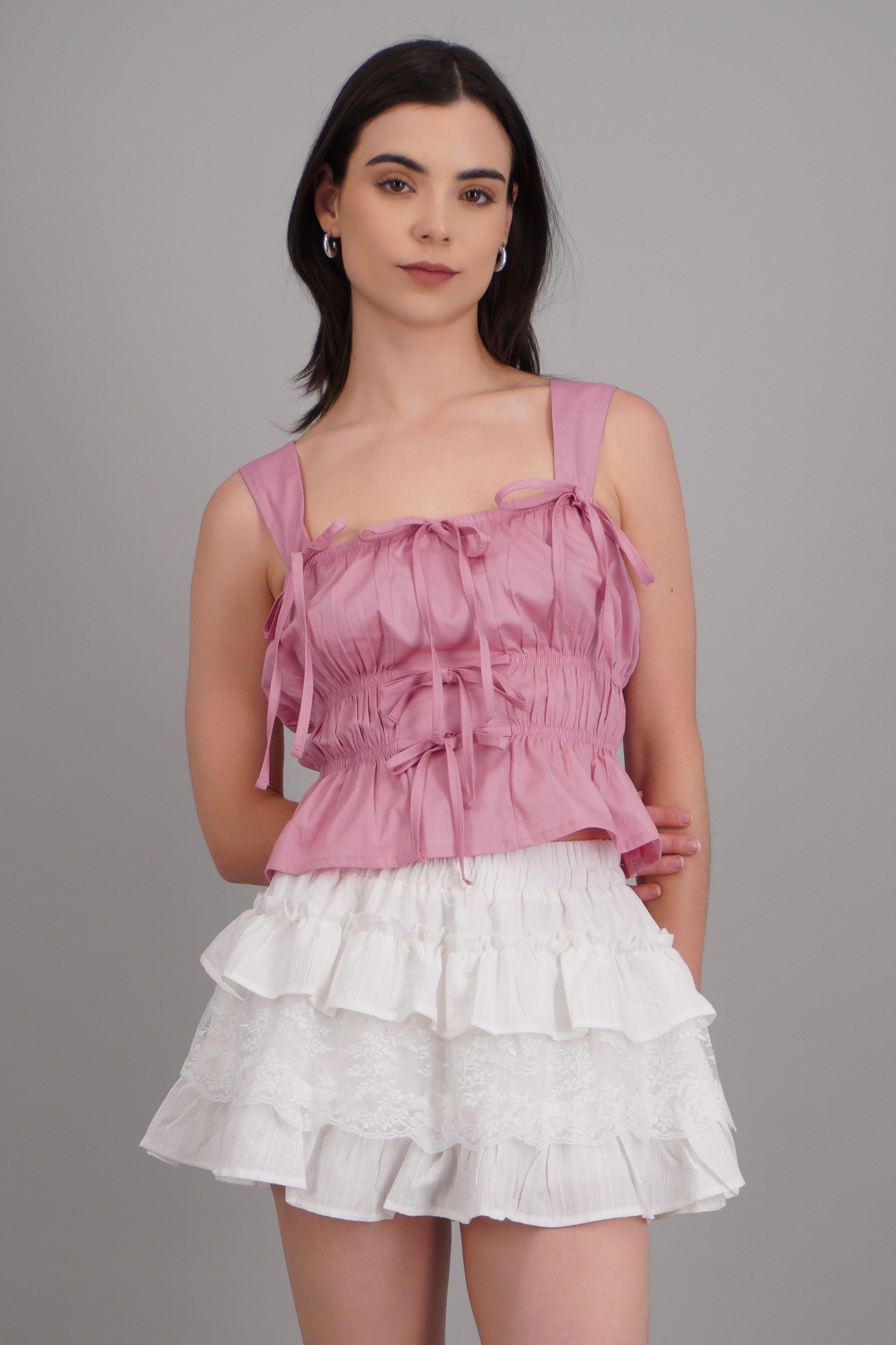 Top sin mangas detalle moños ROSA PASTEL