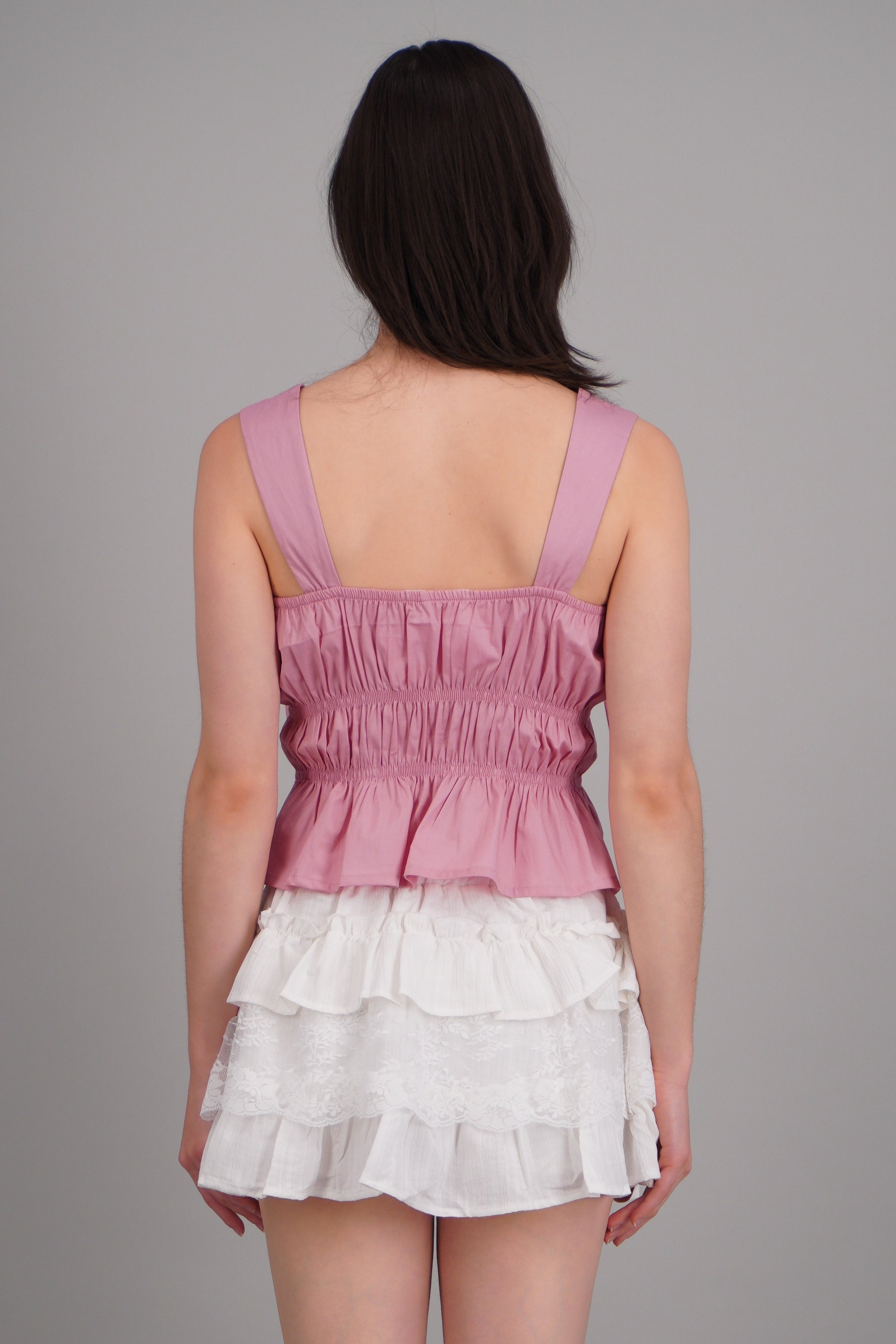 Top sin mangas detalle moños ROSA PASTEL