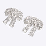 Aretes moños maxi brillos