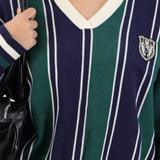 Suéter cuello polo detalle escudo
